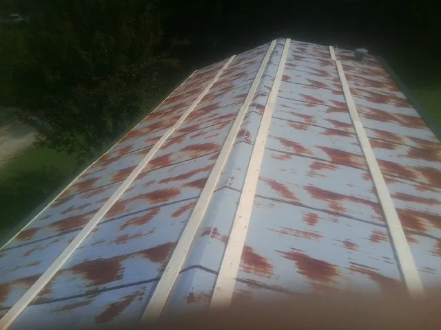 Rusted metal roof panels with new wood purlins before replacement — Storm Damage Roof Repair in Lake Delton by Roofing Brothers
